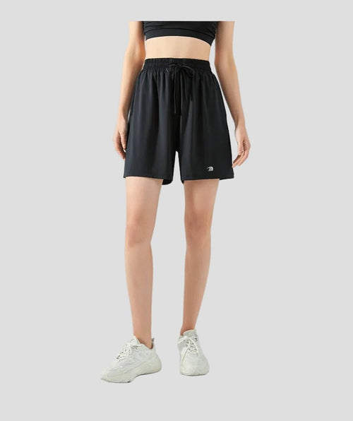 Person wearing black sun protection athletic shorts on a white background