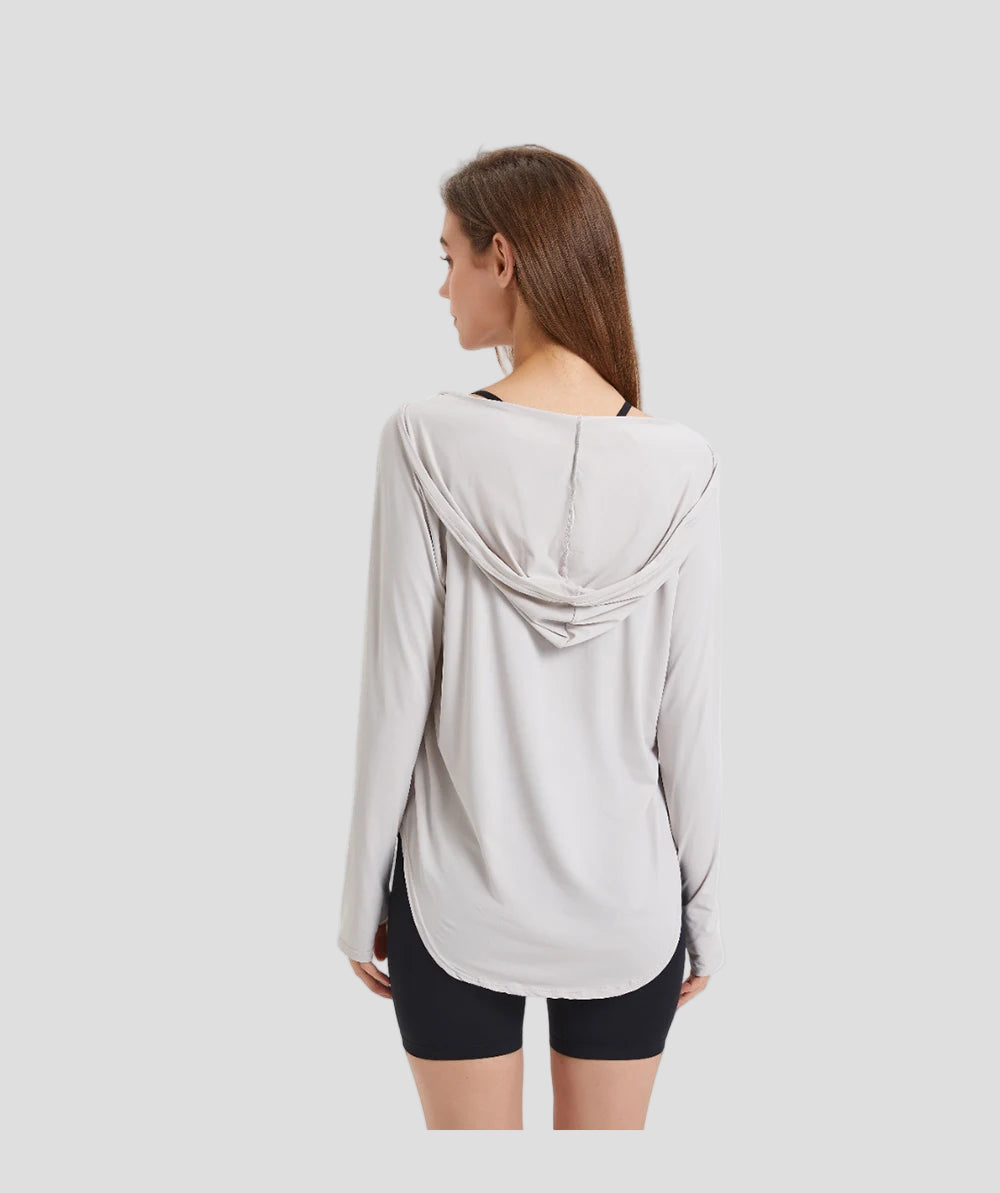 Woman wearing a light gray hoodie on a white background