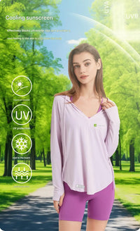 Woman wearing a light purple long-sleeve shirt and purple shorts with sunscreen benefits displayed on a green outdoor background.