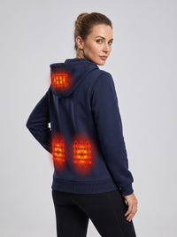 A woman wearing a navy blue heated hooded sweatshirt, shown from the back and side. The image features digital overlays highlighting the glowing heat elements on the back of the hoodie.