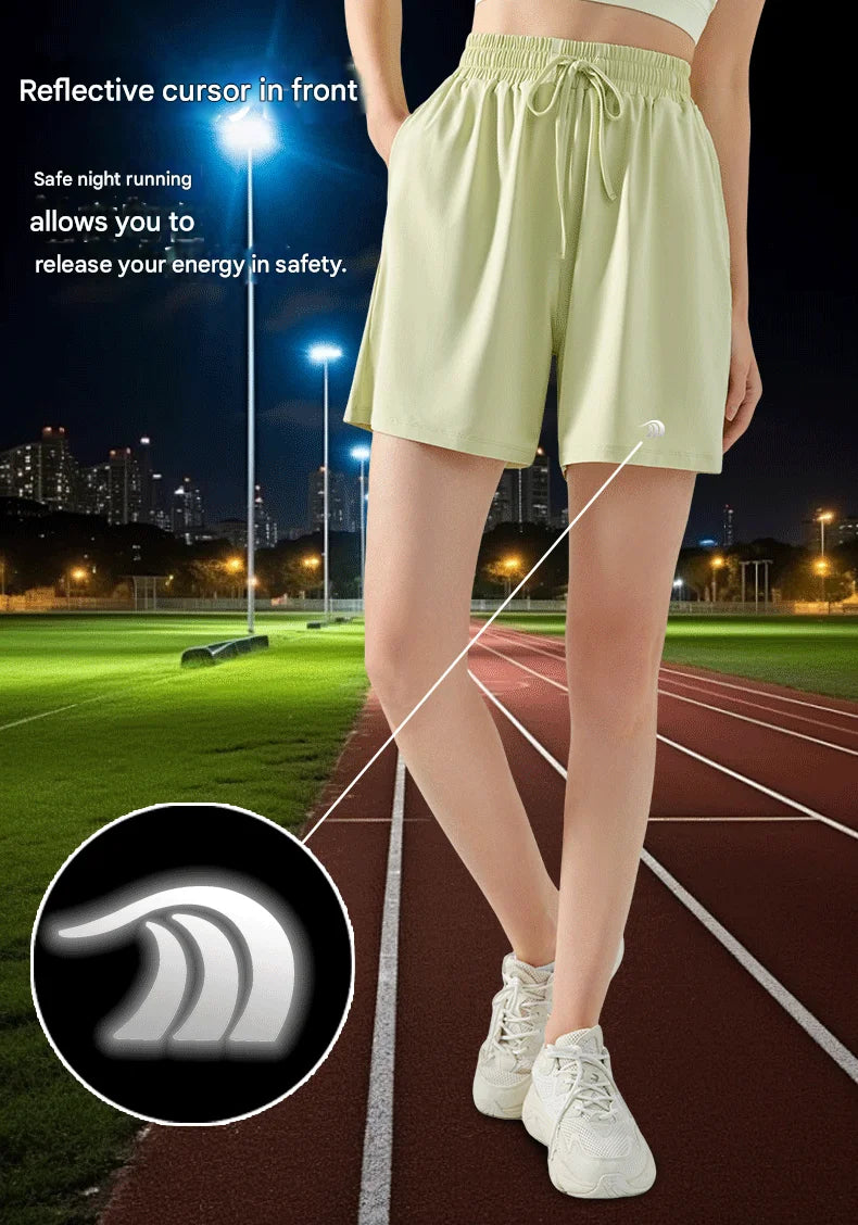 Person wearing light green shorts on a running track with reflective properties highlighted.