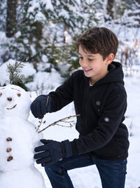 Boy wearing a #black heated hoodie playing in the snow