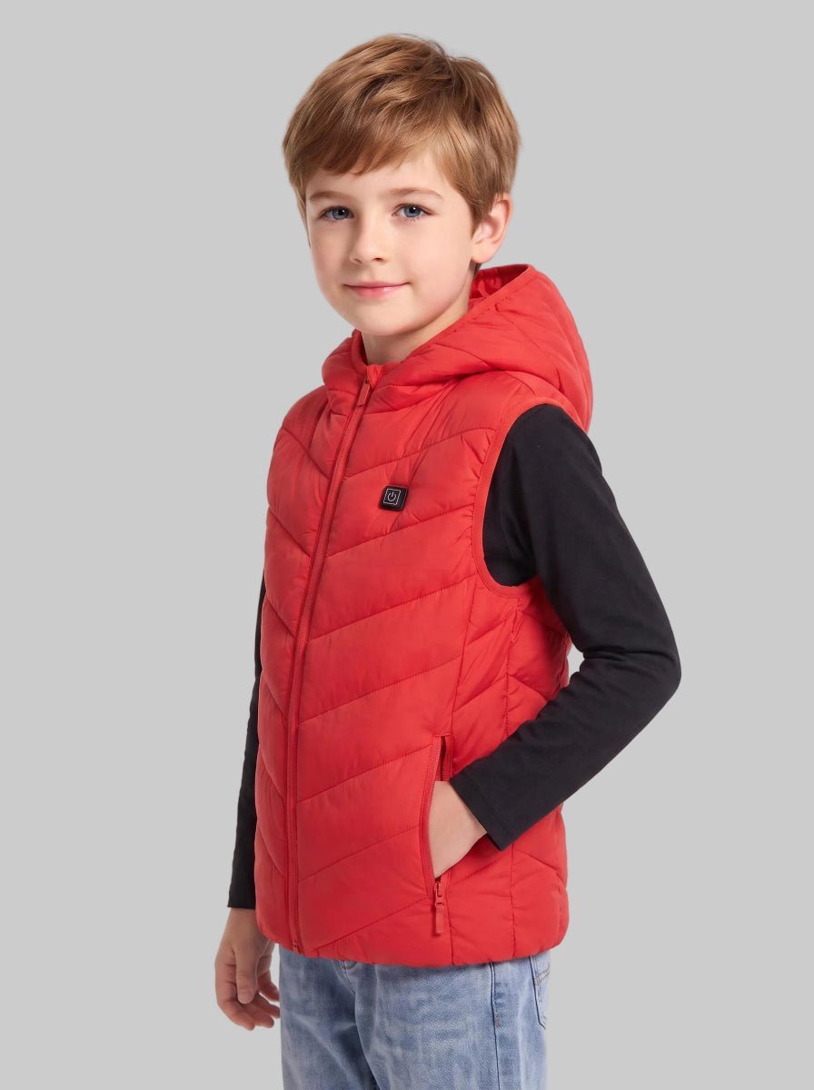 Boy model wearing bright red kids heated hooded puffer vest, sleeveless quilted warm gilet with zipper pockets, plain light‑grey background, children outdoor thermal waistcoat