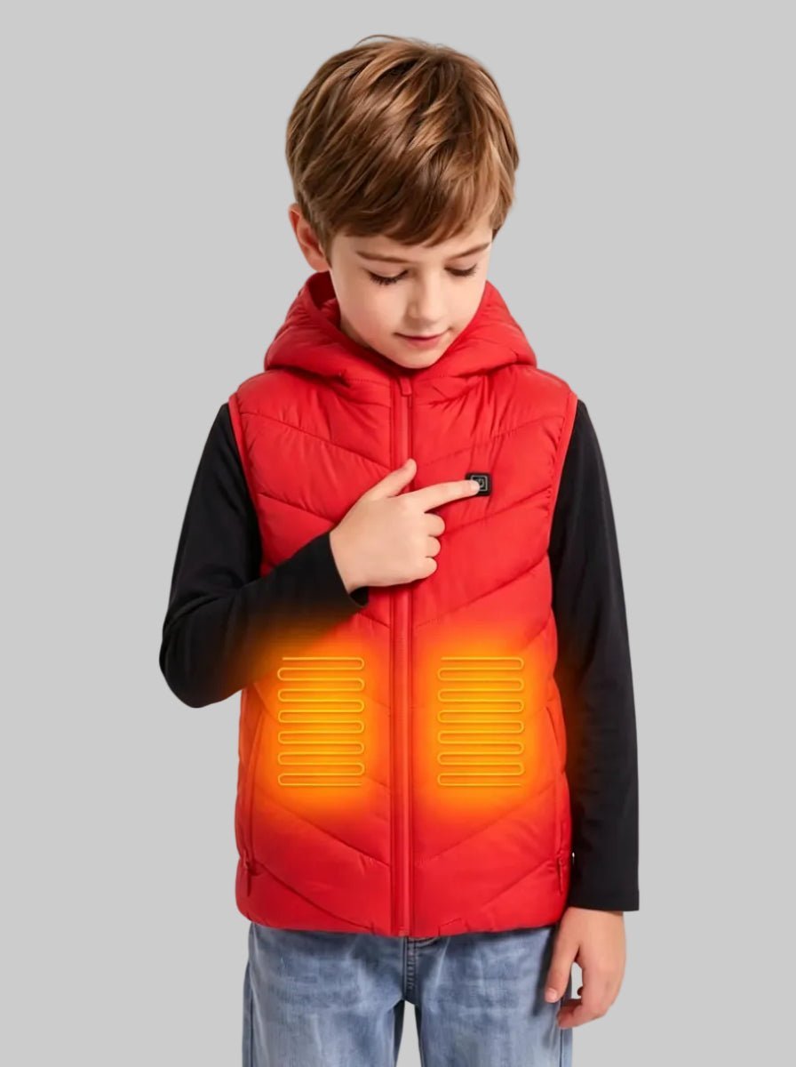 Studio product photo of young boy pressing the control button on red kids hooded heated vest, visual orange heating zones on waist, black long‑sleeve inner shirt, light blue jeans, plain light‑grey background, children warm electric heating outerwear