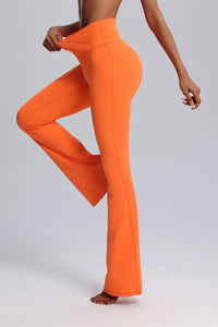 Orange flared pants worn by a person 4 way stretch