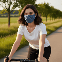 Woman riding a bike on a path with trees in the background