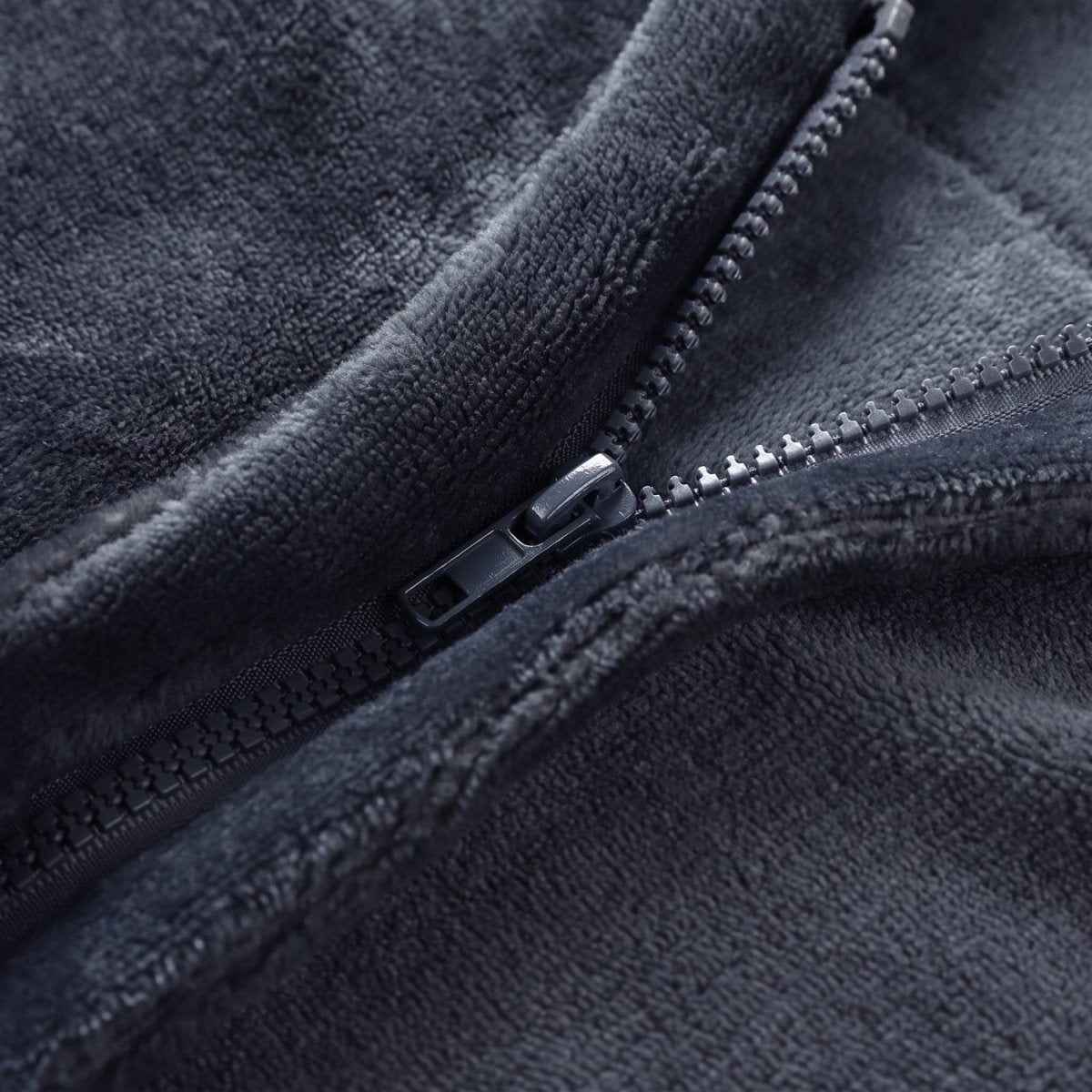 Close-up of sturdy metal zipper on dark grey flannel electric heated shawl, wearable heating blanket zipper detail
