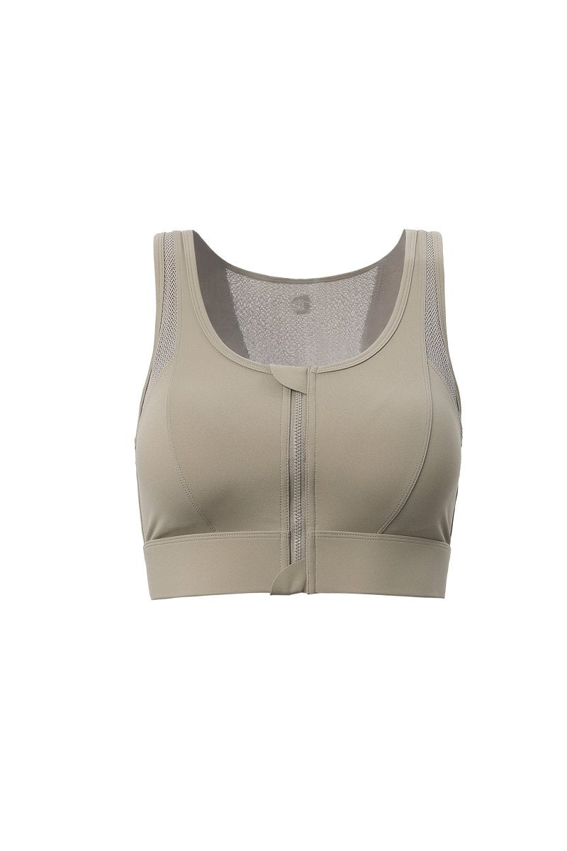 Beige sports bra with mesh panels on a white background
