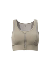 Beige sports bra with mesh panels on a white background