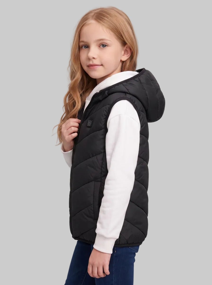 Side profile shot of 10‑11y caucasian girl showing side cut of black kids hooded heated vest, holding zipper pull,display slim fit and vest side seam detail