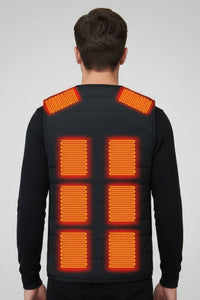 A man viewed from the back wearing a black quilted vest with 8 heat sections on the back and shoulder straps.