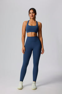 Woman wearing a blue UPF 50+ Yoga outfit with sports bra and leggings