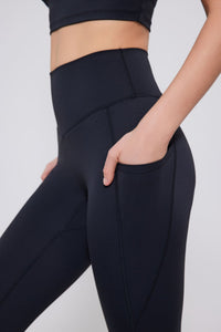 Black High Rise leggings worn by a person on a white background