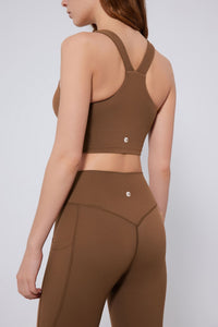 Brown sports bra and leggings set on a plain background