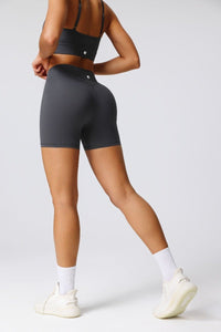 Person wearing black athletic shorts on a white background