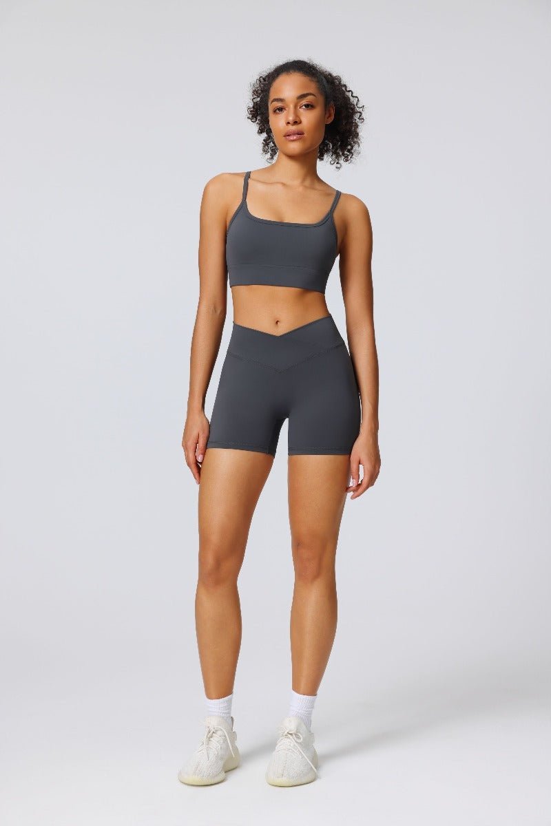 Woman wearing a gray sports bra and yoga shorts set UPF 50+