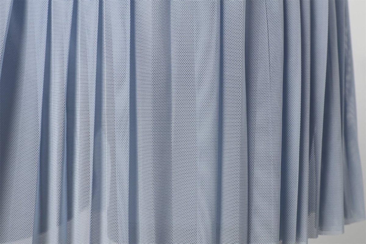 Close - up of a blue mesh fabric for pleated skirt