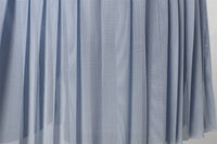 Close - up of a blue mesh fabric for pleated skirt