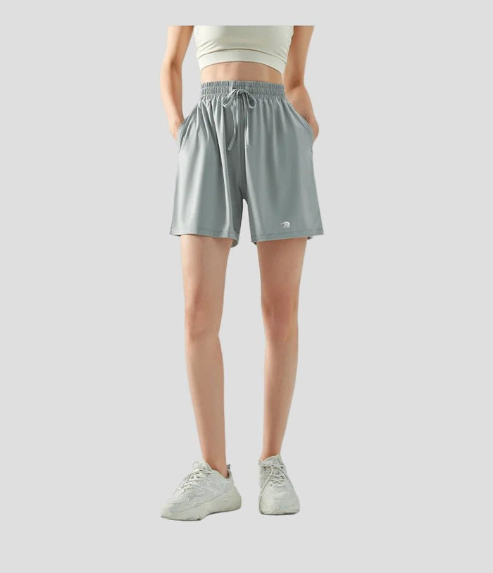 Person wearing light gray sun protection athletic shorts on a white background