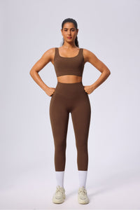 Woman wearing a brown UPF 50+ Yoga vest and leggings outfit