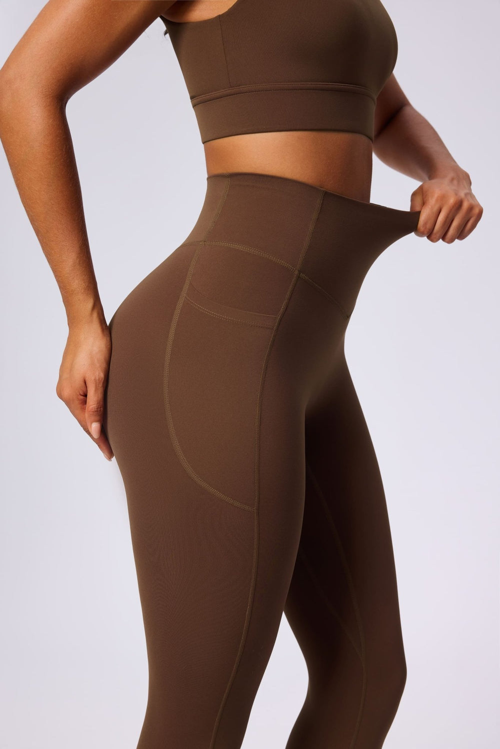 UPF 50+ brown yoga leggings and sports bra on a light gray background