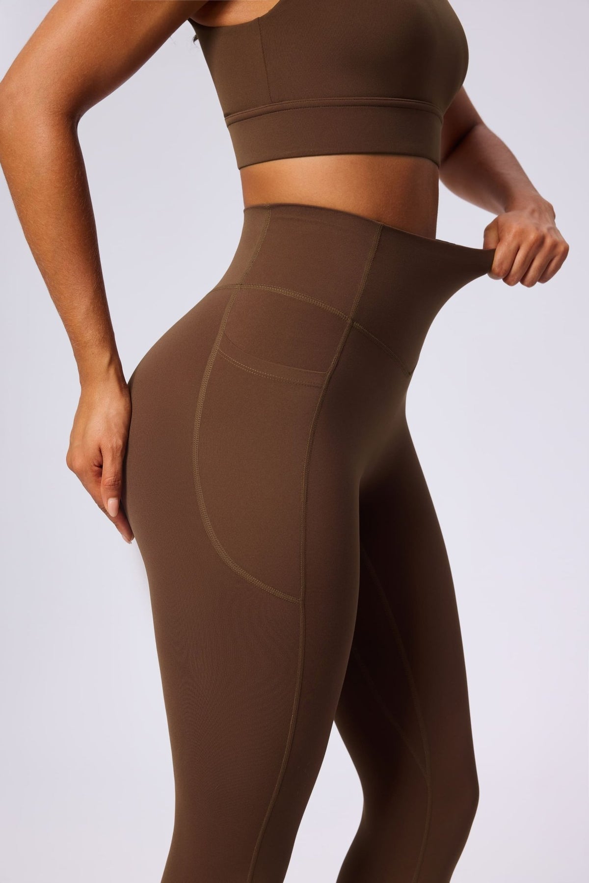 UPF 50+ brown yoga leggings and sports bra on a light gray background