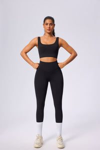 Woman wearing black UPF 50+ Yoga outfit on a white background