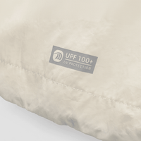 Beige fabric with a UPF 100+ UV protection label beige
