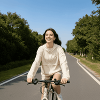 Woman riding a bicycle wearing a Beige Hooded Full Zip Top UPF 100+
