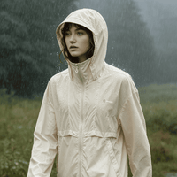 Person wearing a beige raincoat in a rainy outdoor setting