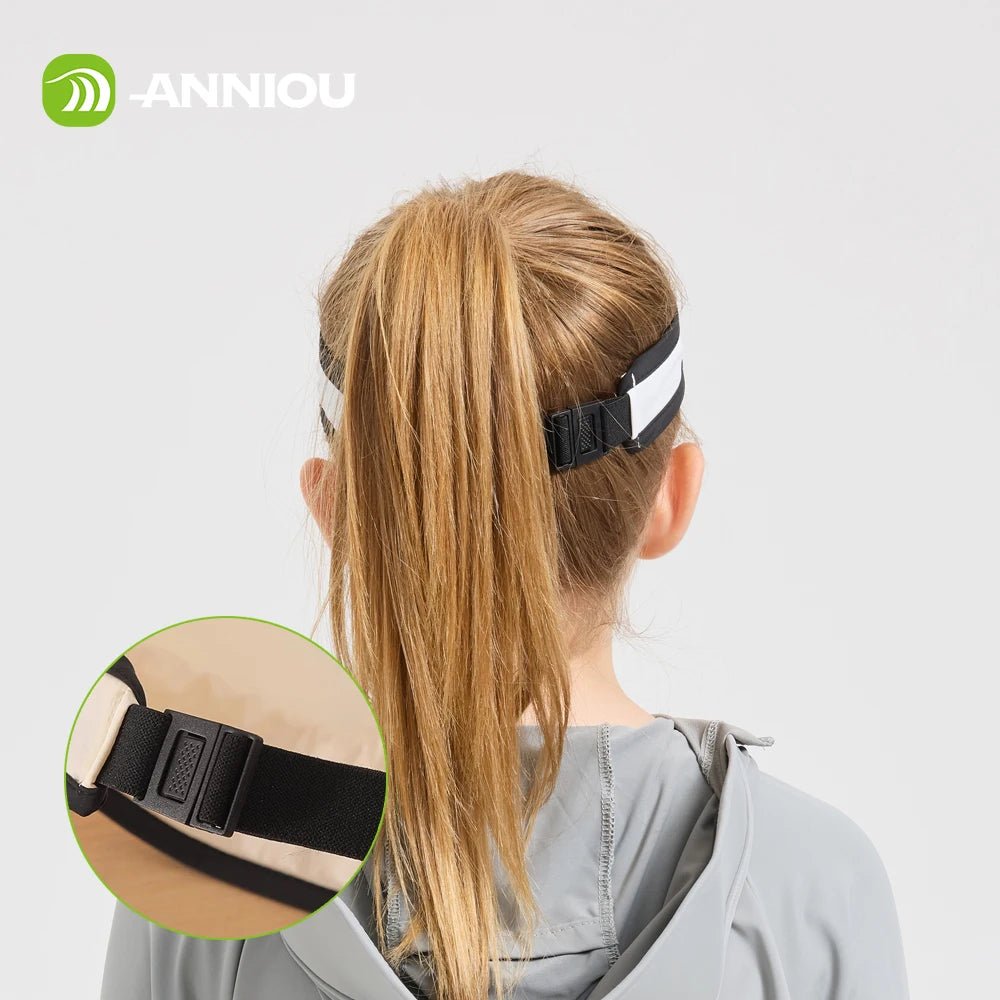 Child wearing a headband with a close - up of the strap on a light gray background, featuring the brand 'ANNIOU'.