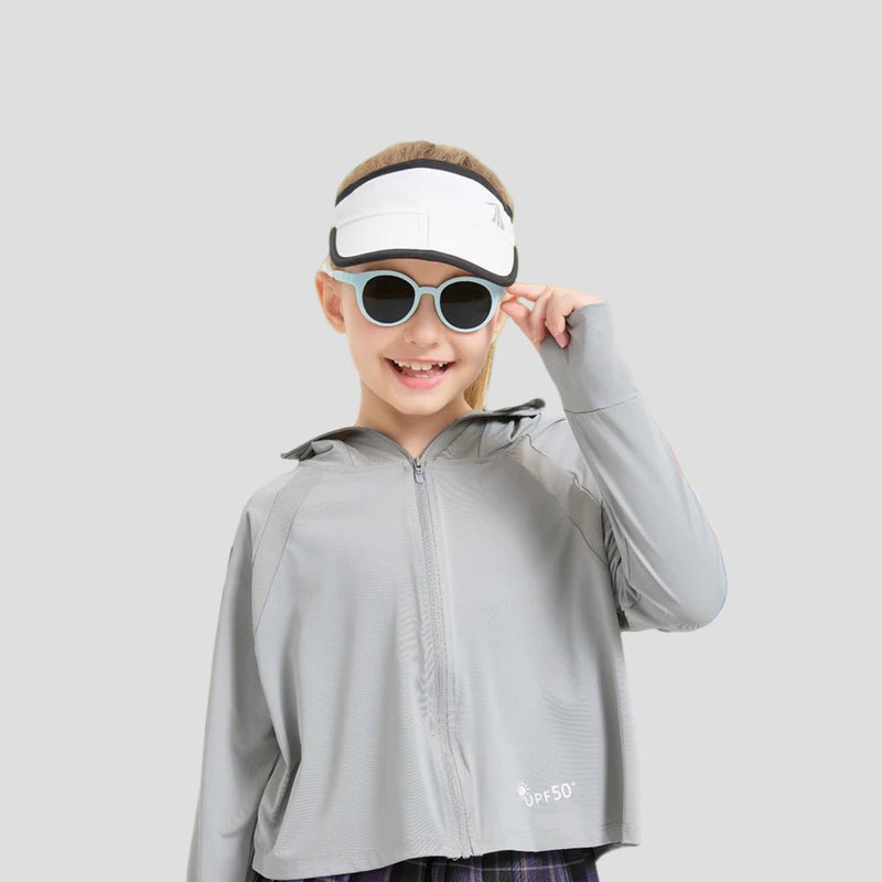 Child wearing a gray jacket with a visor and sunglasses, standing outdoors with 'ANNIOU' branding.