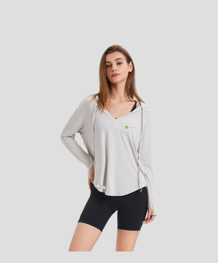  Woman wearing a light gray hoodie UPF 100+ Active Top and black shorts 