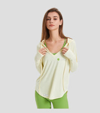 Woman wearing a light green sun protection long-sleeve top and green leggings on a white background