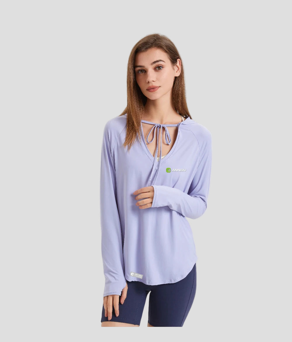 Woman wearing a light purple long-sleeve upf 100 top with a brand logo on a white background