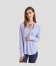Woman wearing a light purple long-sleeve upf 100 top with a brand logo on a white background