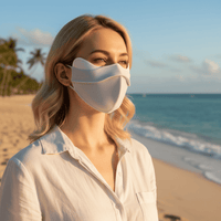 Woman on a beach wearing a gray Lycra UV Face Mask upf 50+