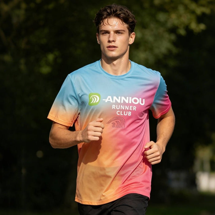 A young man wearing a rainbow gradient T-shirt is running.