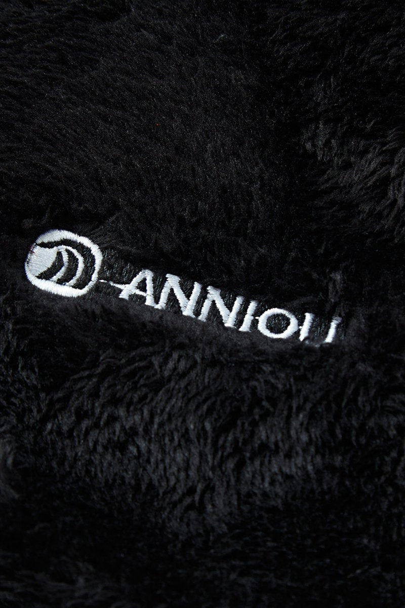 Close - up of a black textured fabric with 'ANNIOU' logo.