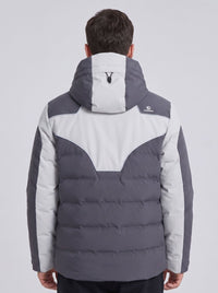 A man viewed from the back wearing a colorblock heated ski puffer jacket in dark gray and light gray, with a hood.