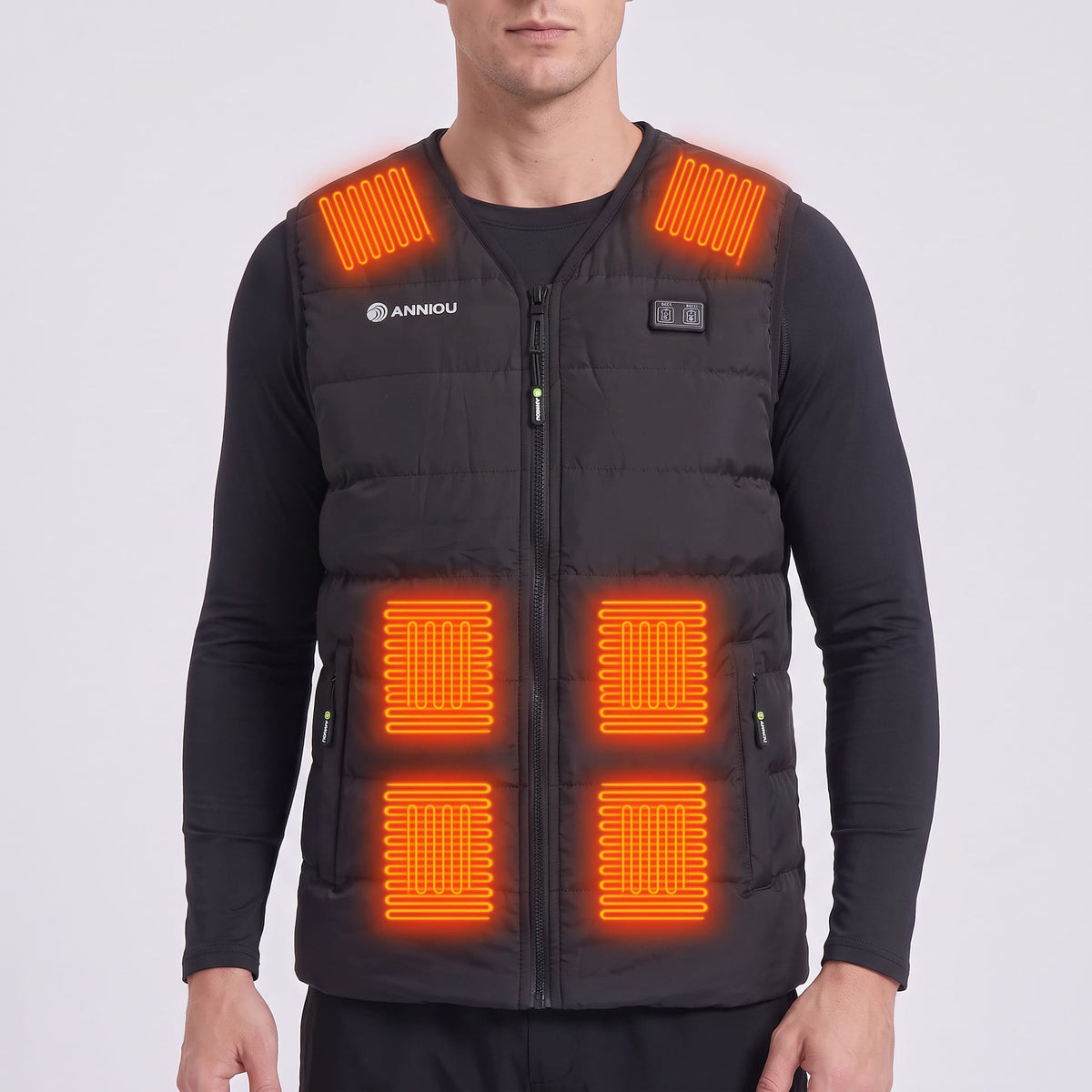 A man wearing a black heated vest with 6 heat pads on the shoulders, belly. The vest has a front zipper, zip pockets, and a visible Annou logo on the left chest.