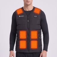A man wearing a black heated vest with 6 heat pads on the shoulders, belly. The vest has a front zipper, zip pockets, and a visible Annou logo on the left chest.