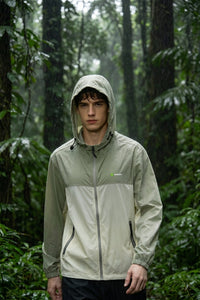 Person wearing a green raincoat in a forest by Anniou