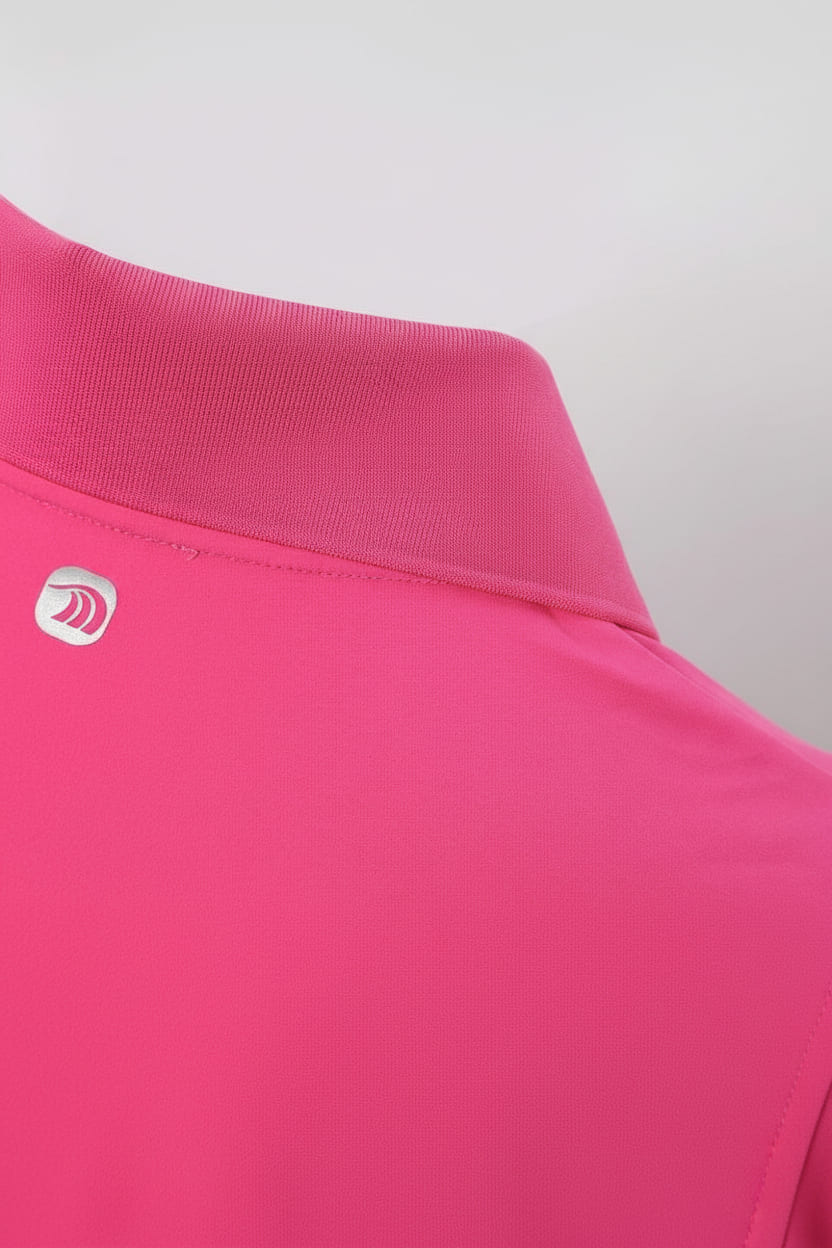 Close - up of a pink polo shirt with a Anniou logo
