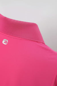 Close - up of a pink polo shirt with a Anniou logo