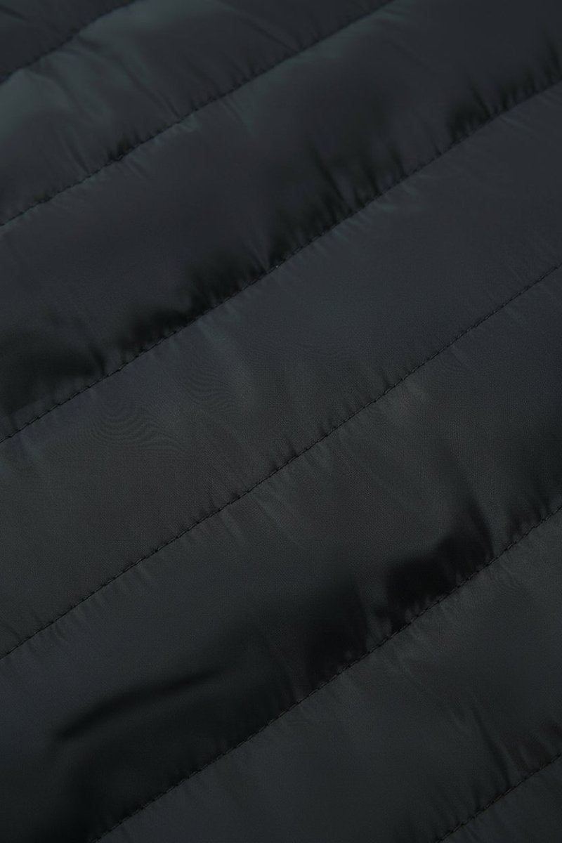 Close-up of a dark quilted puffer jacket fabric with diagonal stitching.
