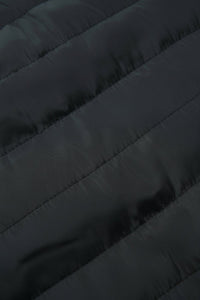 Close-up of a dark quilted puffer jacket fabric with diagonal stitching.