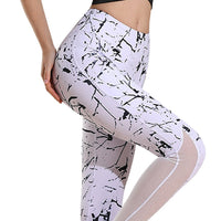 White leggings with black abstract pattern worn by a person on a white background