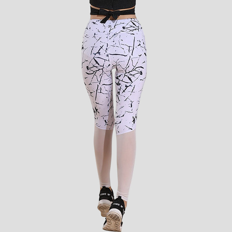 White leggings with black abstract pattern worn by a person on a white background