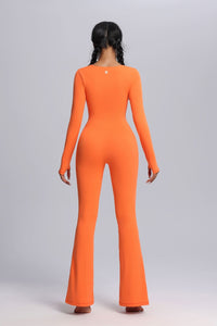 Person wearing an YOGA orange jumpsuit on a plain background